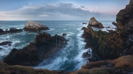 Photo for Amazing panorama of the sea cliffs on the northern Scottish coast and rough seas. Famous rock formation on the Moray Coast, Scottish Highlands, Scotland - Royalty Free Image