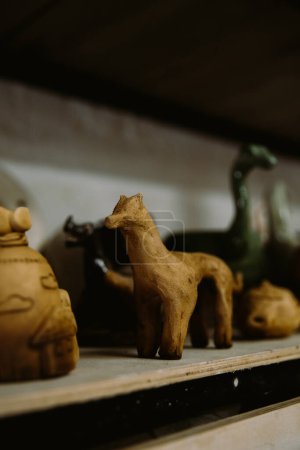 Téléchargez les photos : Vue rapprochée de la figure de cheval d'argile sur la table en bois - en image libre de droit