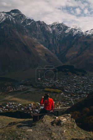 Photo for Rear view of a young woman looks on the Mount Kazbek in Georgia - Royalty Free Image