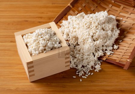 Foto de Rice koji in a colander and Masu on the table. Koji. Koji is fermented rice. - Imagen libre de derechos