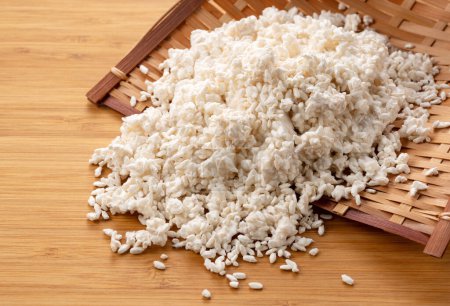 Foto de Rice koji in a colander on the table. Koji. Koji is fermented rice. - Imagen libre de derechos