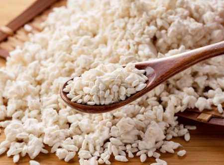 Foto de Rice koji in a colander on the table and a wooden spoon. Koji. Koji is fermented rice. - Imagen libre de derechos