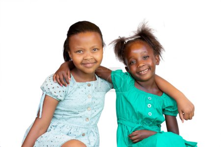 Foto de Close-up Studio portrait of two young African kids sitting together. Isolated on white background. - Imagen libre de derechos