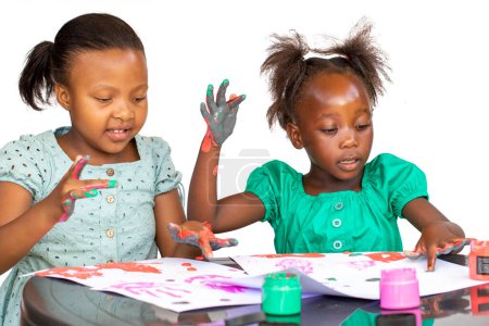 Photo for Portrait of African kids painting with color paint. Isolated against a white background. - Royalty Free Image