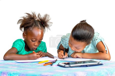 Photo for Two little African kids drawing with wax crayons at a desk. Isolated against a white background. - Royalty Free Image