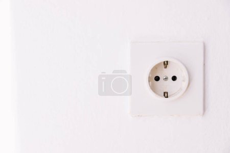 Photo for Power socket on the empty white wall - Royalty Free Image