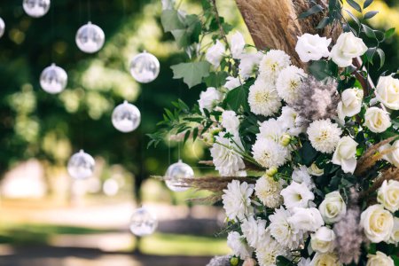 Photo for Garland of bulbs hanging on laces near decor with white flowers. Wedding decoration - Royalty Free Image