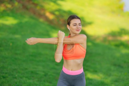 Photo for Beautiful young woman stretching exercises outdoor. Healthy women concept. - Royalty Free Image