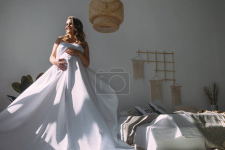 Photo for Pregnant girl with white cloth. The concept of health in anticipation of birth, tenderness, happiness of motherhood - Royalty Free Image