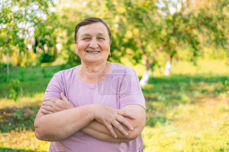 Photo for Portrait of senior woman smiling and looking at camera. Cheerful mature woman in the village. Carefree and positive retired woman. - Royalty Free Image