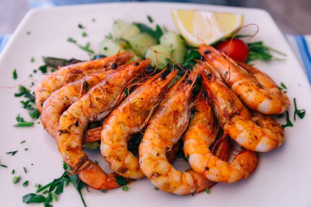 Photo for Grilled tiger shrimp with parsley sauce and lemon. - Royalty Free Image