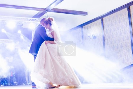 Photo for Dad and daughter dance in the restaurant hall. hall with light and smoke. - Royalty Free Image