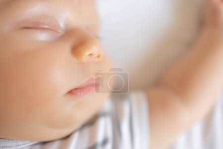 Photo for Little newborn baby boy closeup sleeping in the bed. - Royalty Free Image