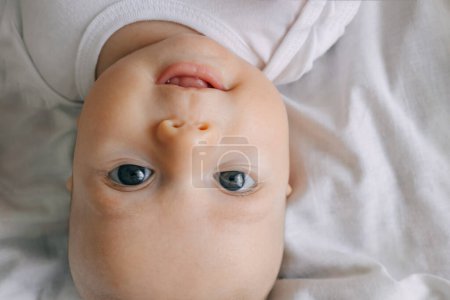 Photo for Cute baby smiling and looking in the camera close up. Little kid top view - Royalty Free Image