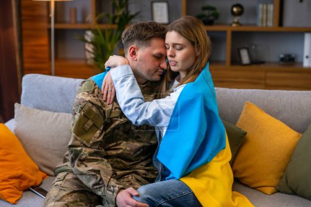 Photo for Sad woman crying when hugging her military husband and saying-goodby to him. - Royalty Free Image
