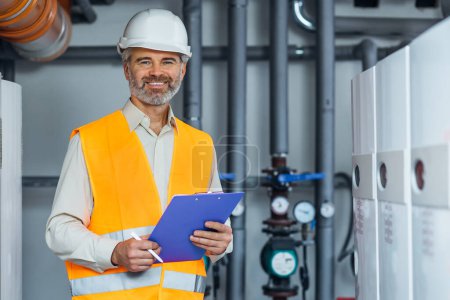 Photo for Engineer staff worker with checking schedule listing smile at camera - Royalty Free Image