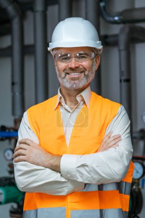 Photo for Portrait of a Professional Engineer Worker Wearing Uniform, Glasses and Hard Hat in a Steel Petrol Factory. - Royalty Free Image