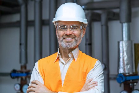 Photo for Senior gray haired Engineer Manufacture Worker. Caucasian man in Hard Hat and Safety Wear. Confident Older Attractive Mechanic of Machine Inspection for Machinery Tool Job Indoors - Royalty Free Image
