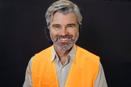 Photo for Head shot portrait of handsome smiling man wearing headset at office looking at camera. Call center introduction. Happy employee at workplace. People at work. Private entrepreneur. - Royalty Free Image