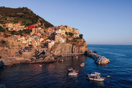 Photo for Colorful traditional houses on a cliff above the Mediterranean at sunset, Manarola, Cinque Terre, Italy. - Royalty Free Image