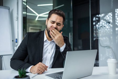 Photo for Bored yawning man Caucasian male businessman lazy office worker manager sit at desk indoors working with laptop need nap - Royalty Free Image