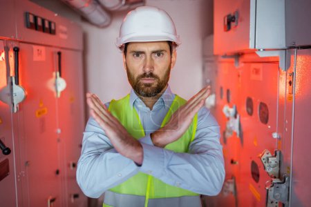 worker man wearing uniform and security helmet Rejection expression crossing arms and palms doing negative sign, angry face