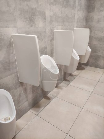 Photo for Urinals men on wall public toilet. Public restroom for men. - Royalty Free Image