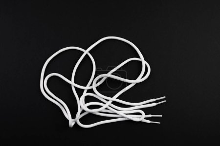 Photo for White long shoe laces on a black - Royalty Free Image