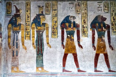 Four people standing in a line on the wall of the tomb of Ramesses III in the Valley of the Kings near Luxor, Egypt