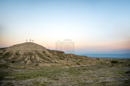 Three crosses on a hill in the soft early morning light in the Tatacoa Desert in Colombia