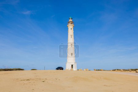 California lighthouse in desert against blue sky of southern coast of island of Aruba.