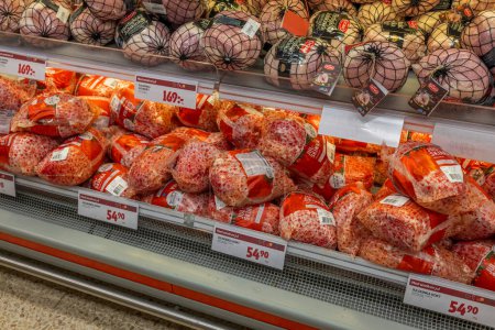 Photo for Close up view of counter with frozen Christmas ham in supermarket. Sweden. Uppsala. 12.14.2022. - Royalty Free Image