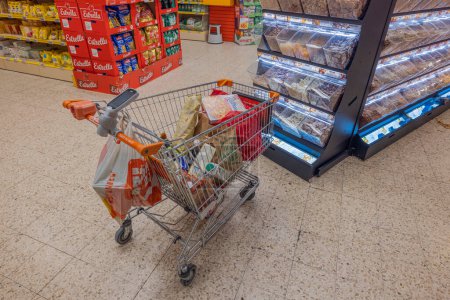 Photo for Close up view of cart with of buying groceries in mall. Sweden. Uppsala. 12.14.2022. - Royalty Free Image
