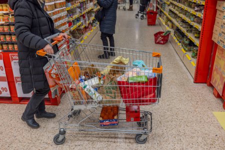 Photo for Interior view of customer with food purchases in shopping cart in ICA supermarket. Sweden. Uppsala. 12.14.2022. - Royalty Free Image
