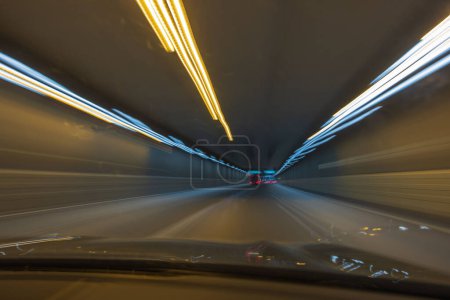 Photo for Beautiful view of defocused colorful tracers of tunnel road lights from car window. Sweden. Stockholm. - Royalty Free Image