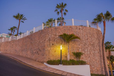 Photo for Beautiful view of fenced hotel area at top of mountain hill on evening sky background. Spain. Gran Canaria. - Royalty Free Image