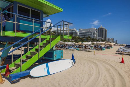 Photo for View of lifeguard tower with surfboard on sandy beach in Miami Beach. - Royalty Free Image