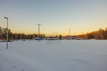Photo for Beautiful winter view of stadium with ski tracks and building of sports club. Sweden. Storvreta. - Royalty Free Image