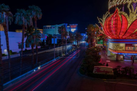 Photo for Aptivating nocturnal scene of Las Vegas featuring mesmerizing blurred light trails left by cars on bustling Strip Road. Las Vegas. USA. - Royalty Free Image