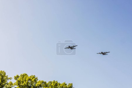 Photo for A stunning view of two military aircraft in flight above the treetops. Sweden. - Royalty Free Image