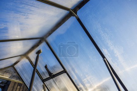 Close-up view of a steam cleaner being used to clean the interior of a greenhouse, preparing it for the new planting season. Sweden.