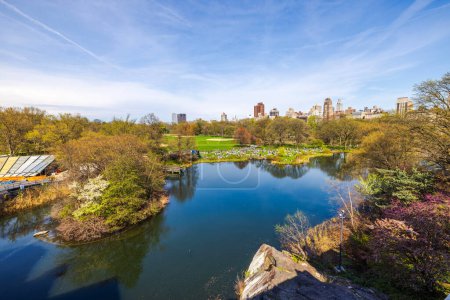 Beautiful view from the top of Belvedere Castle of the lake and green lawns with people relaxing in Central Park, Manhattan. New York. USA.