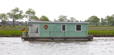 Photo for Houseboat on the move in the Netherlands, canal - Royalty Free Image