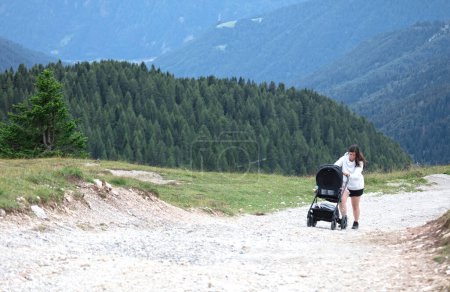 Photo for Woman with buggy in the mountains, Dolomites Italy - Royalty Free Image