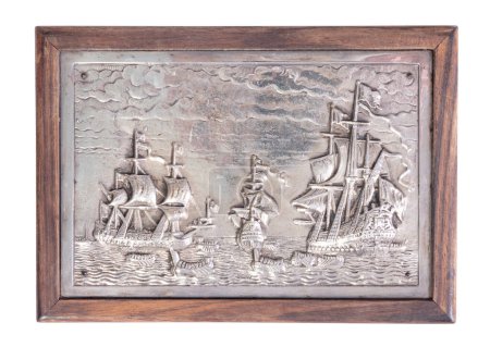 Very old cigarette case with a silver outside showing tall ships, isolated