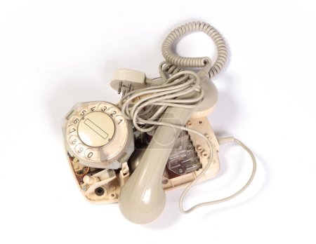 Part of a broken old telephone, phone with dial plate - plastic phone, isolated