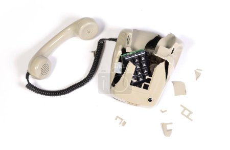 Part of a broken old telephone, phone with dial plate - plastic phone, isolated