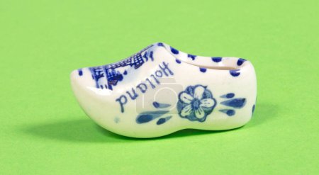 Miniature dutch wooden shoe souvenir on a white background, typical dutch souvenir