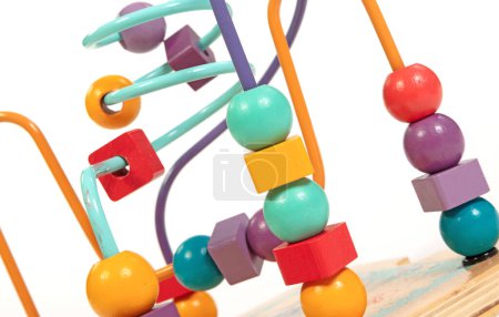 Children's developing toy, a labyrinth of wooden beads isolated on a white baskground