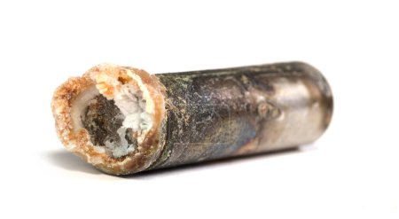 Unbranded corroded alkaline battery leaking potassium hydroxide, isolated